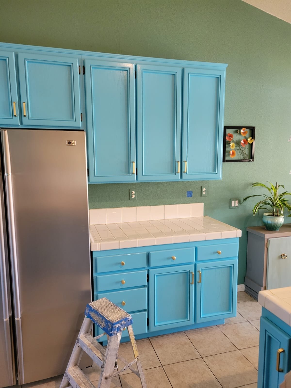 Kitchen cabinets refinished in a bright blue colour