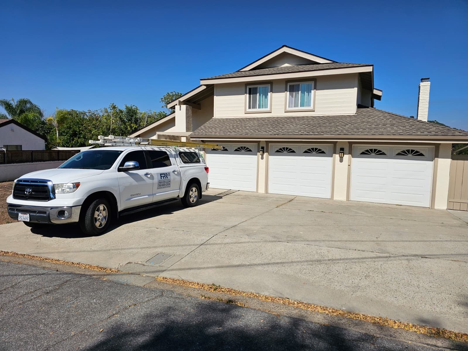 Fercho's painting service vehicle outside a completed home project