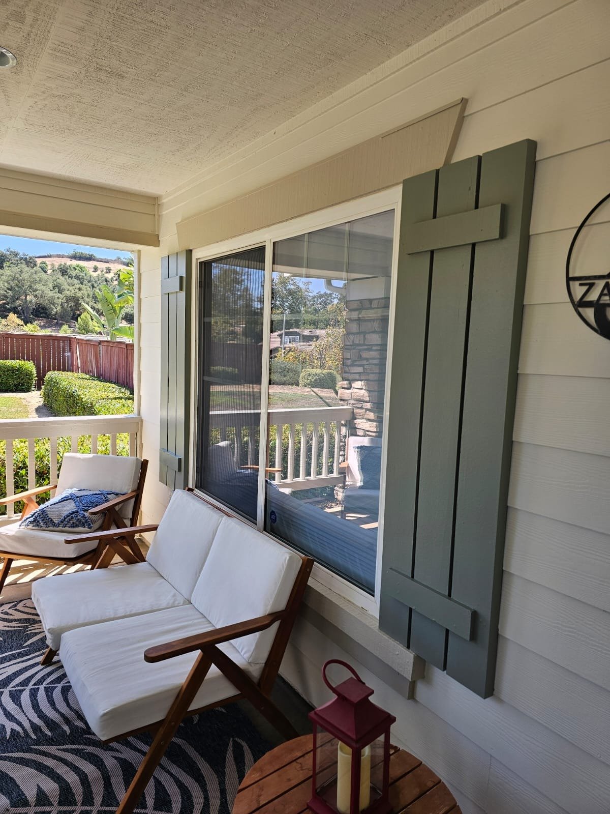 Restored residential porch, siding and window shutters