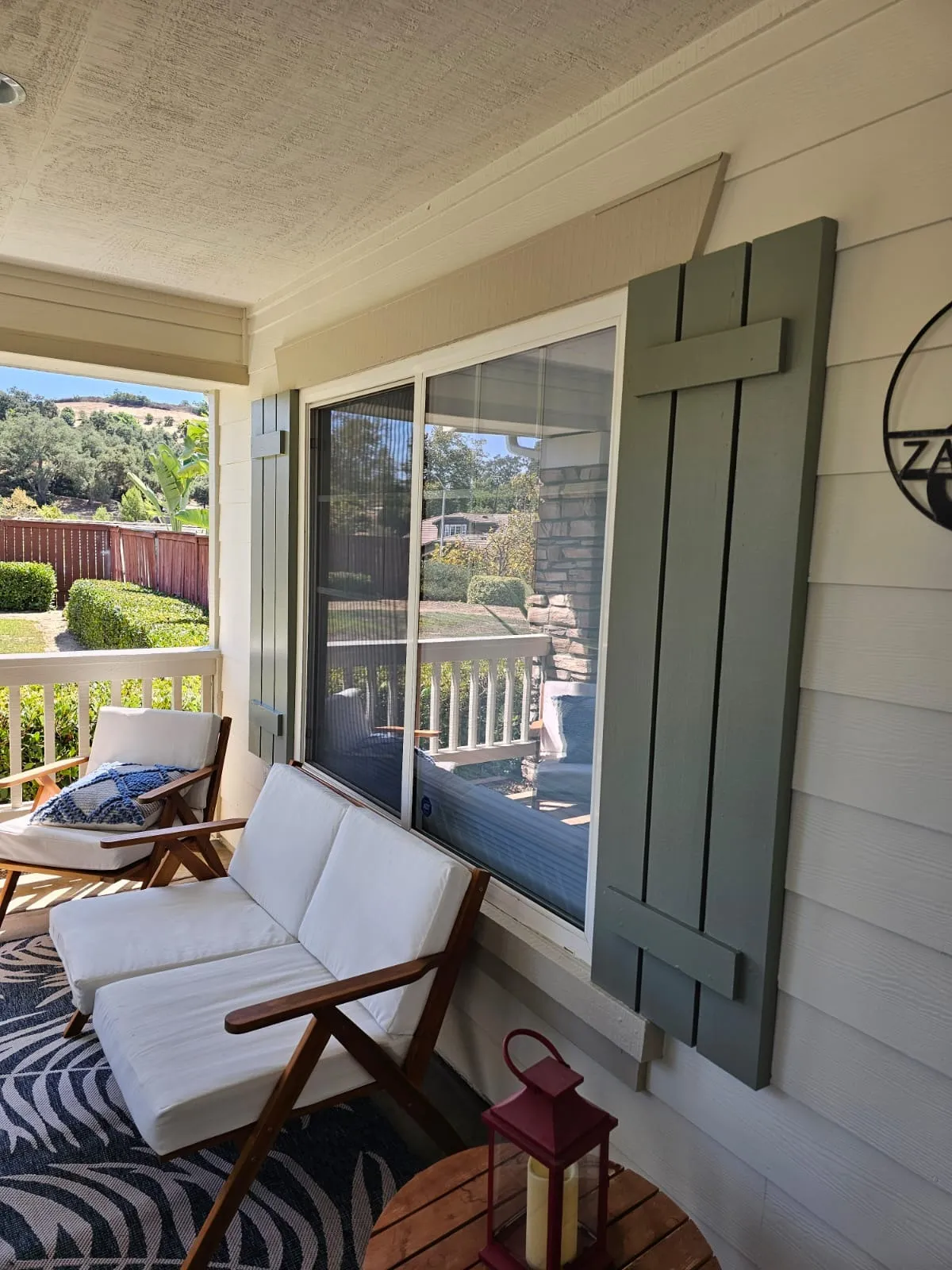 Restored residential porch, siding and window shutters